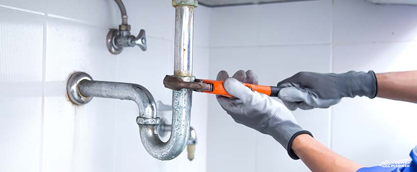 ABP-Technician plumber using a wrench