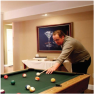 A man playing pool in a remodeled space